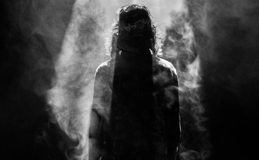 man shrouded in black and white shadows